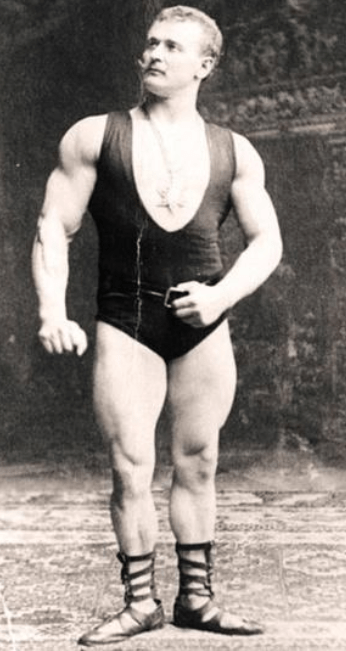 Eugen Sandow posing in sandals and a singlet