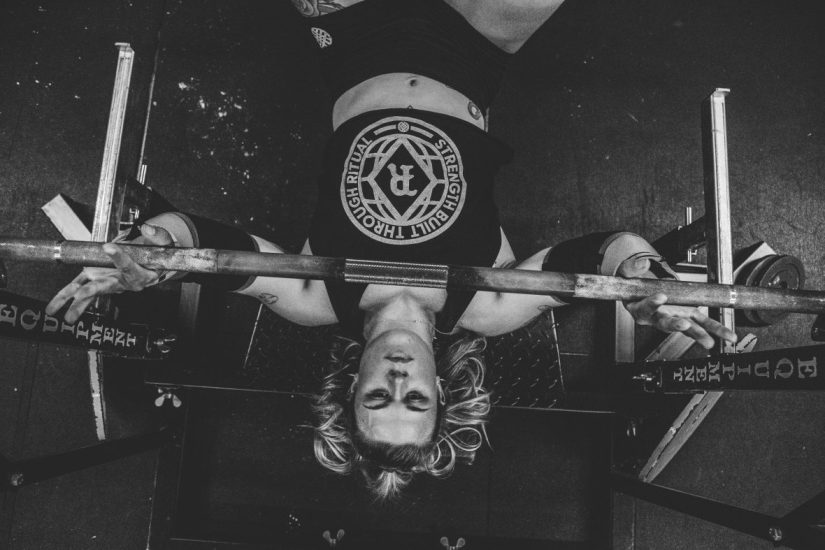 Overhead view of a woman setting up in the bench press position